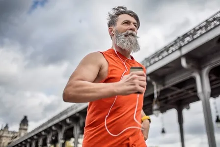 Un homme barbu fait du jogging.